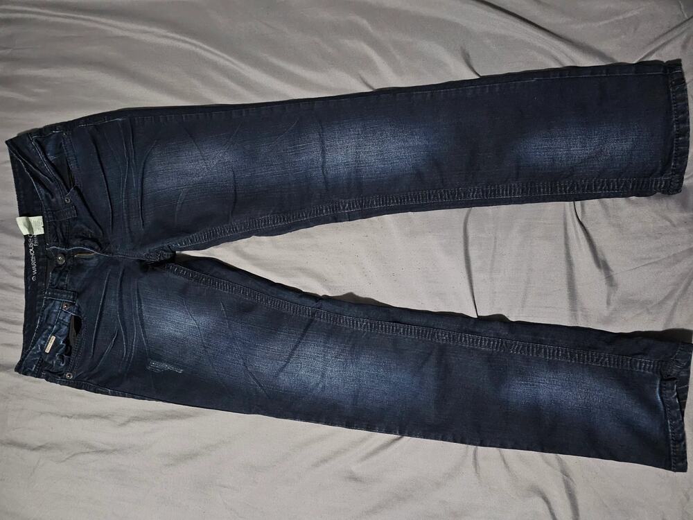 Dark wash denim jeans with straight leg fit and five pocket design